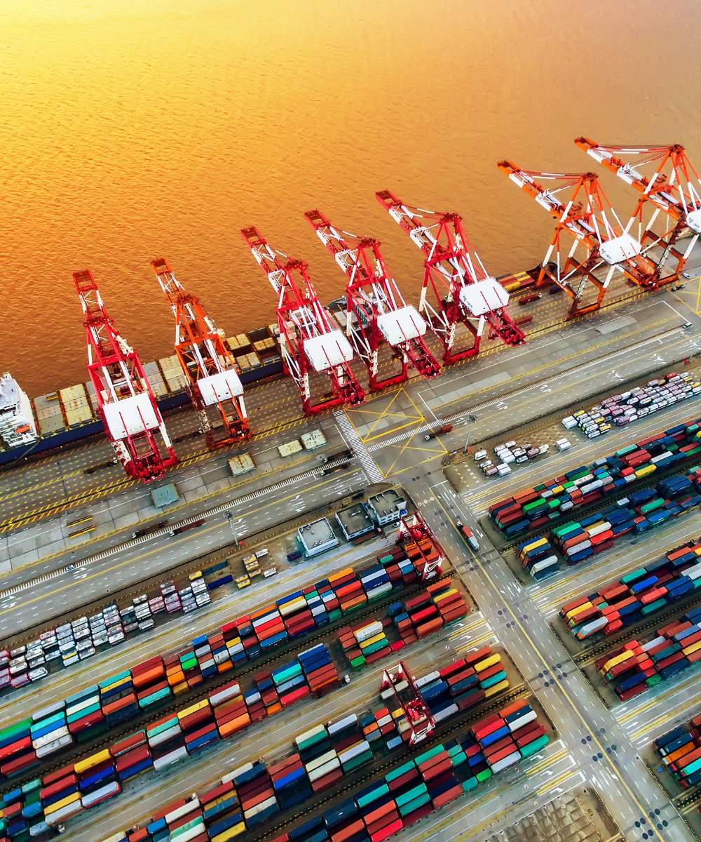 Container ship being maneuvered to shipyard by tugboats