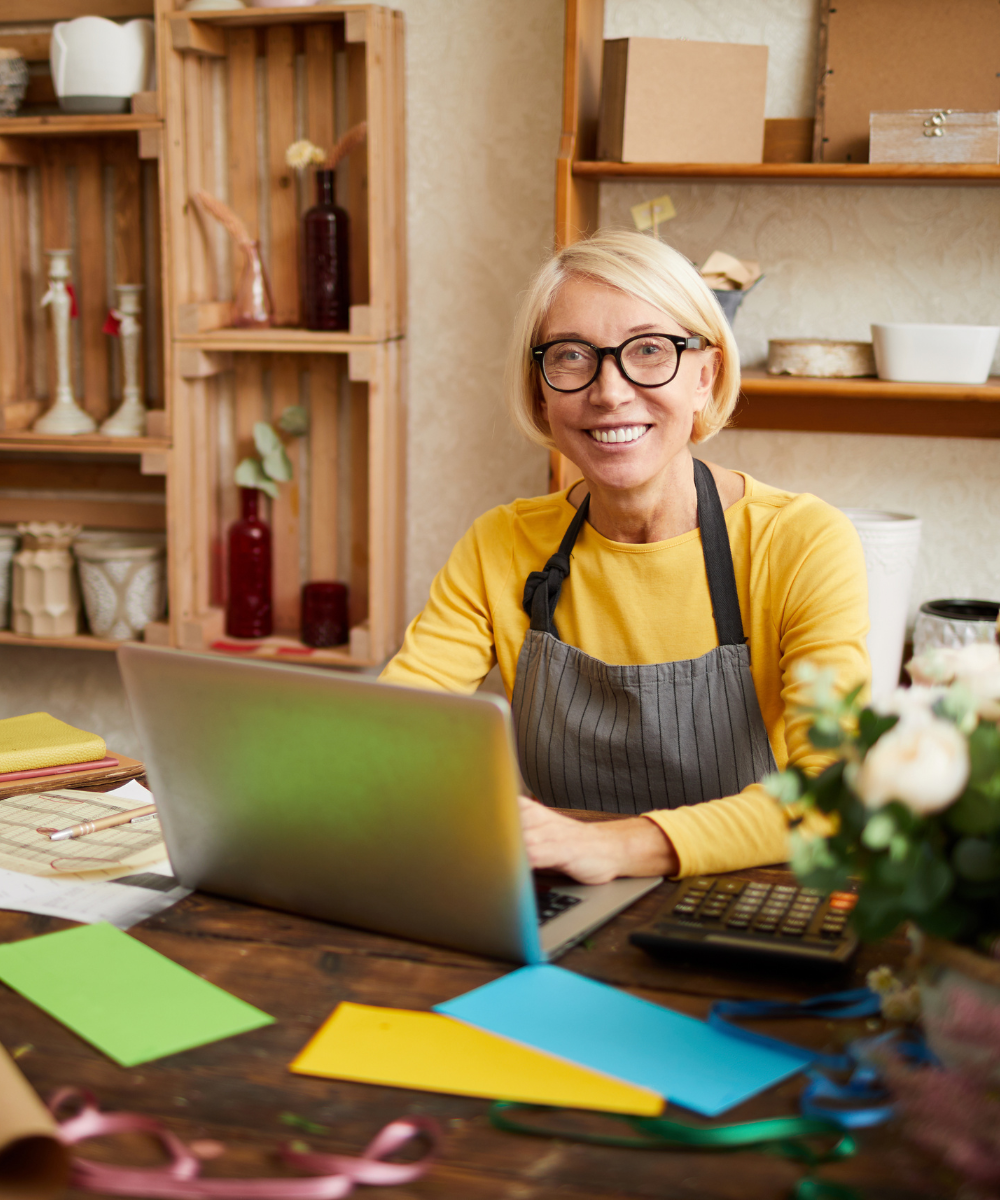 Person seated at laptop in florist shop