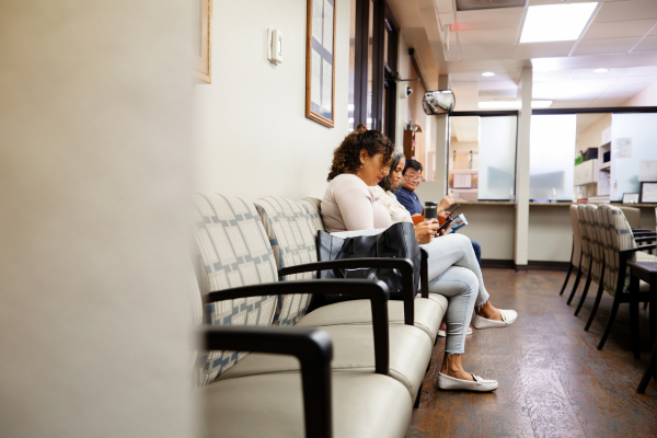 People seated in healthcare clinic waiting room